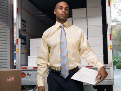 A man standing by a loaded moving truck